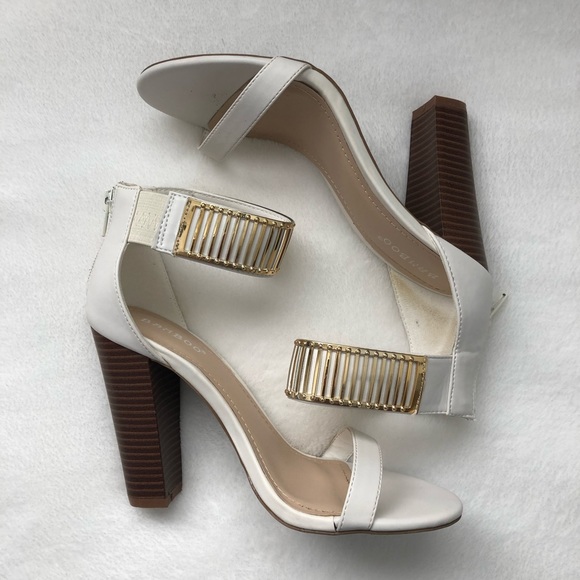 white heels with gold accents